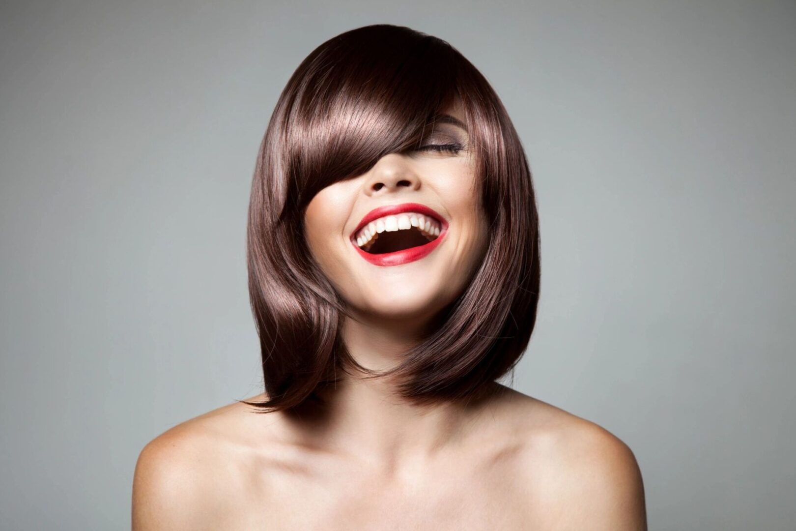 A woman with brown hair and red lipstick.