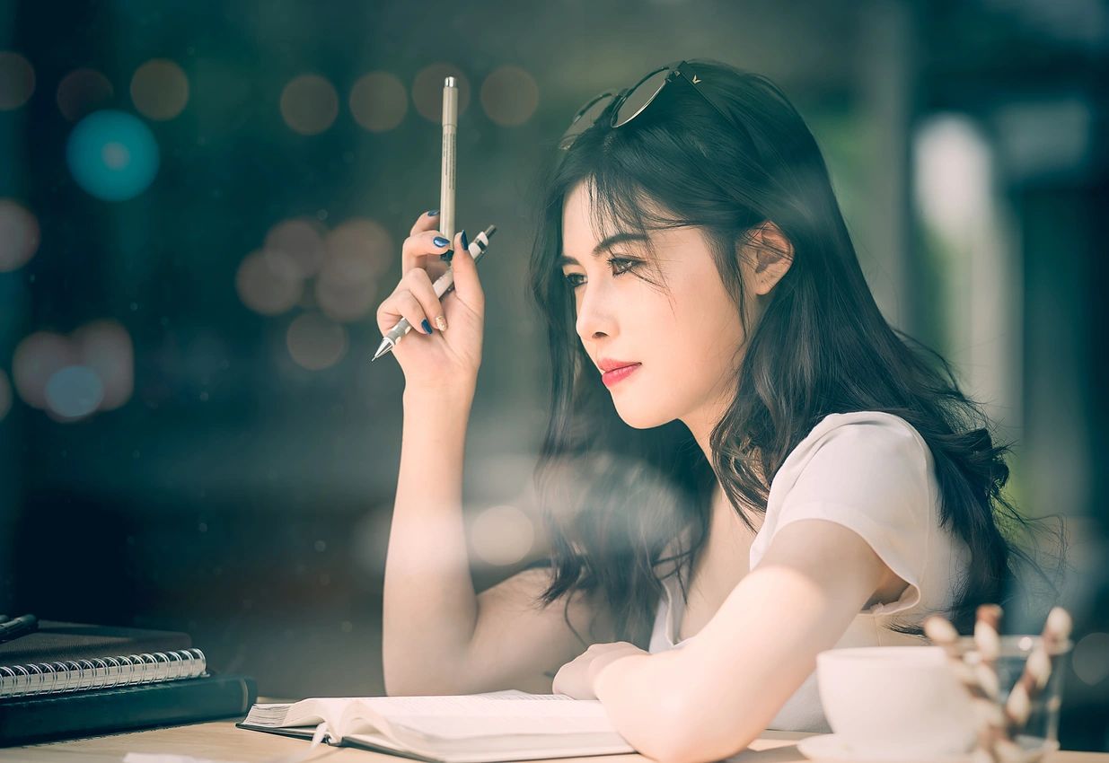A woman holding a pencil in her hand.