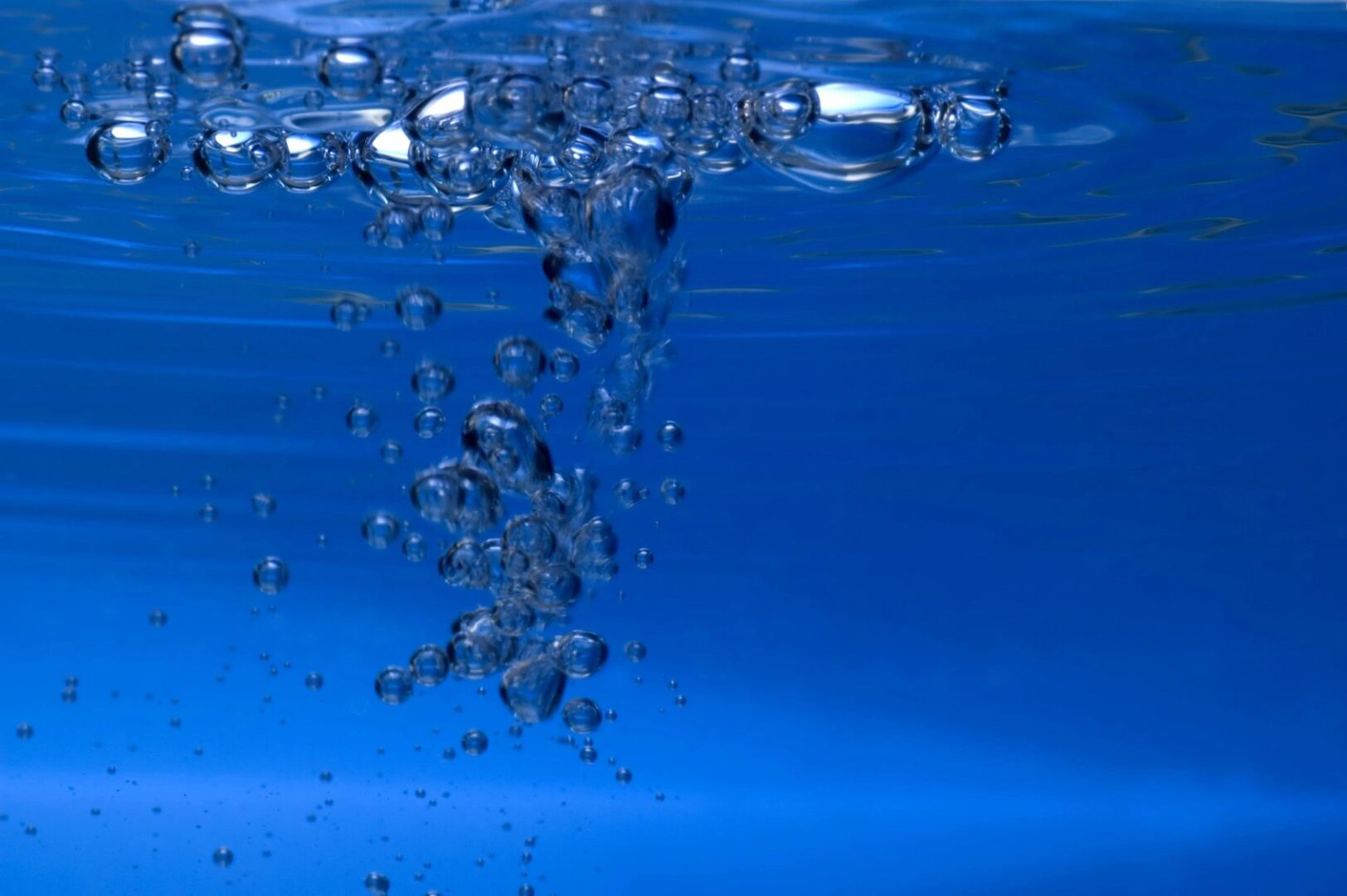 A blue sky with bubbles floating in it