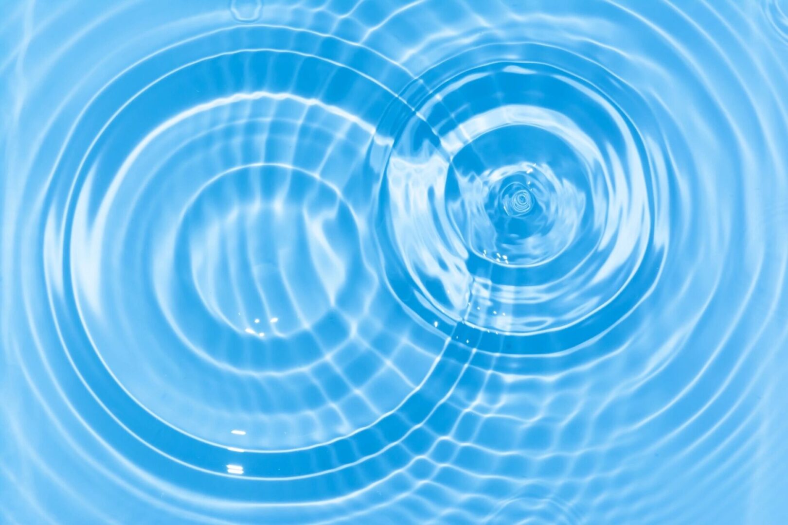 A blue water background with circles in the middle.