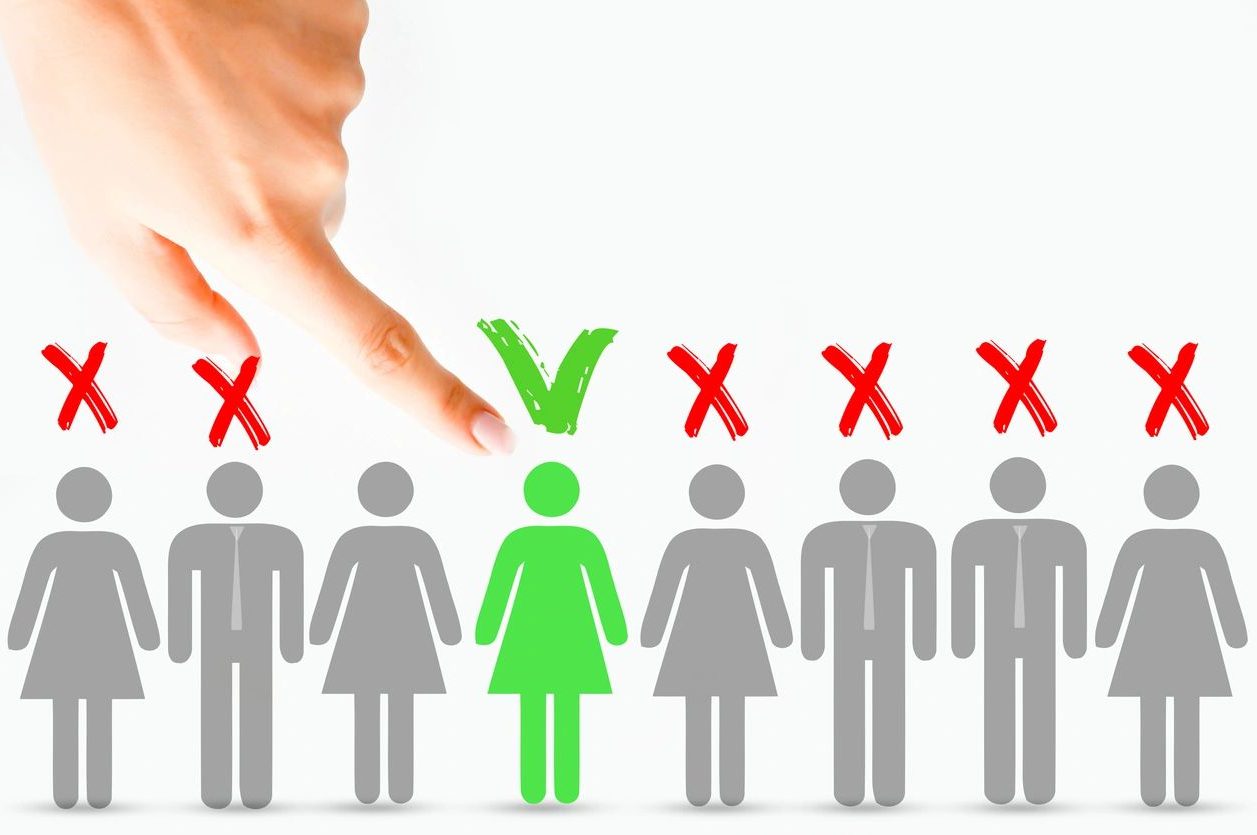 A hand is touching an individual 's green tick.